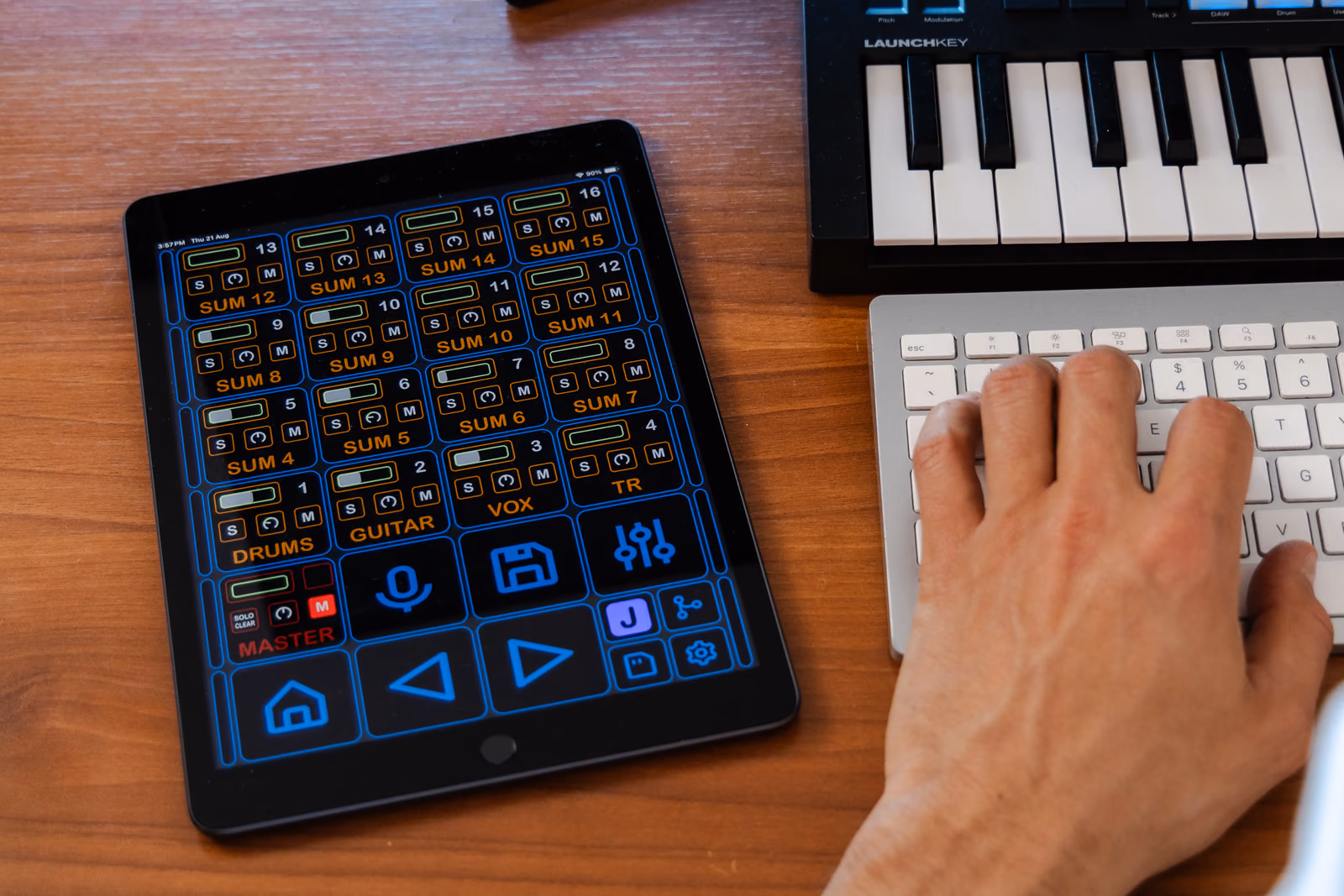 Alltimix running on an iPad on a desk: DRUMS, GUITAR and VOX channels with their own faders